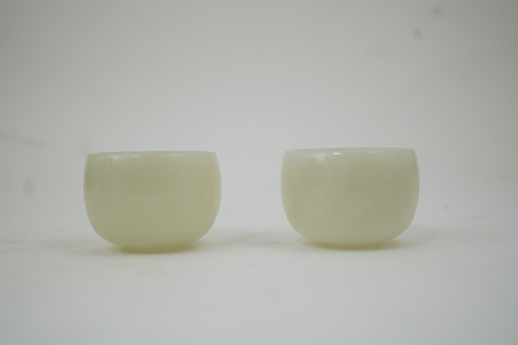 A pair of Chinese white jade cups, Qing dynasty or later